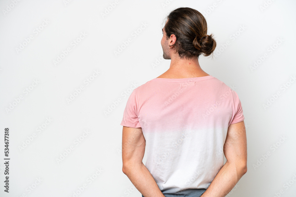 Caucasian handsome man isolated on white background in back position and looking back Caucasian handsome man isolated on white background in back position and looking back