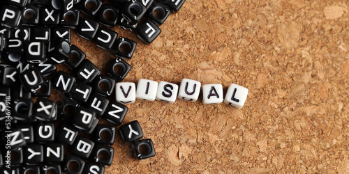 Принти на полотні Closeup of word on plastic cube on wooden desk background concept - visual