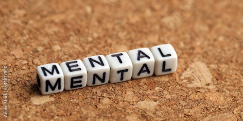 Closeup of word on plastic cube on wooden desk background concept - dental