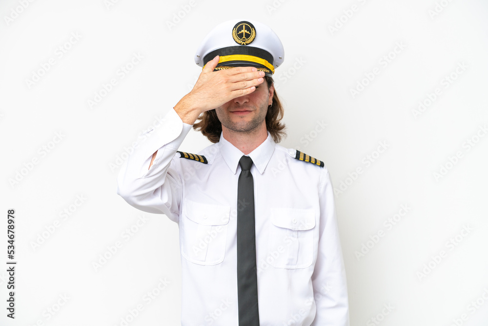 handsome Airplane pilot isolated on white background covering eyes by hands. Do not want to see something