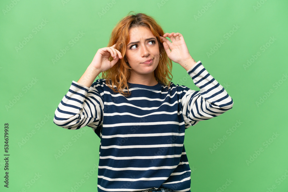 Young caucasian woman isolated on green screen chroma key background having doubts and thinking Young caucasian woman isolated on green screen chroma key background having doubts and thinking