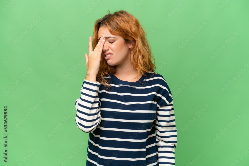Young caucasian woman isolated on green screen chroma key background with headache Young caucasian woman isolated on green screen chroma key background with headache
