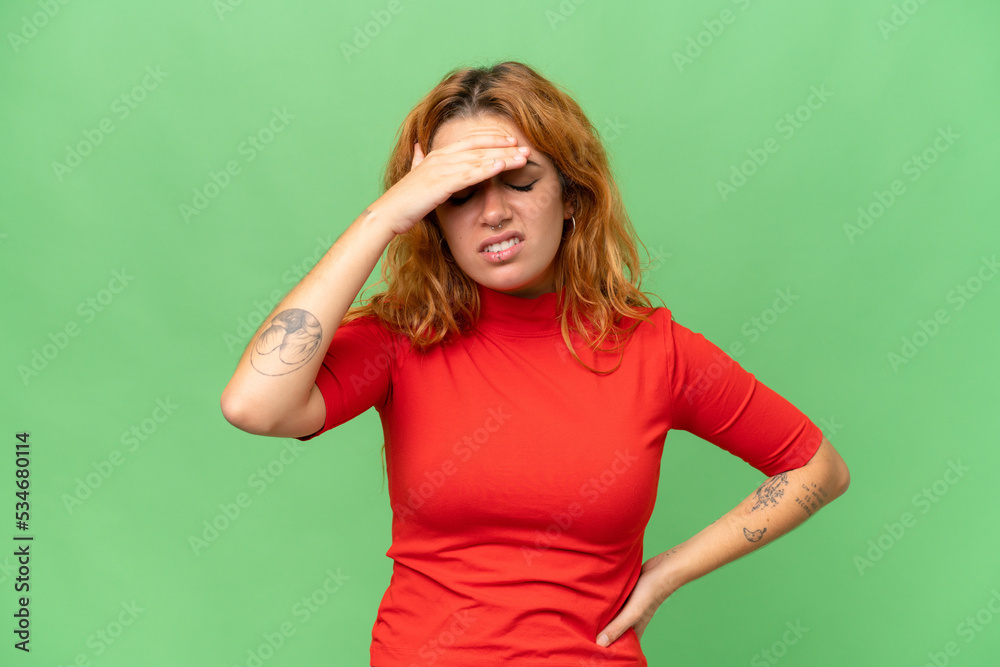 Young caucasian woman isolated on green screen chroma key background with headache
