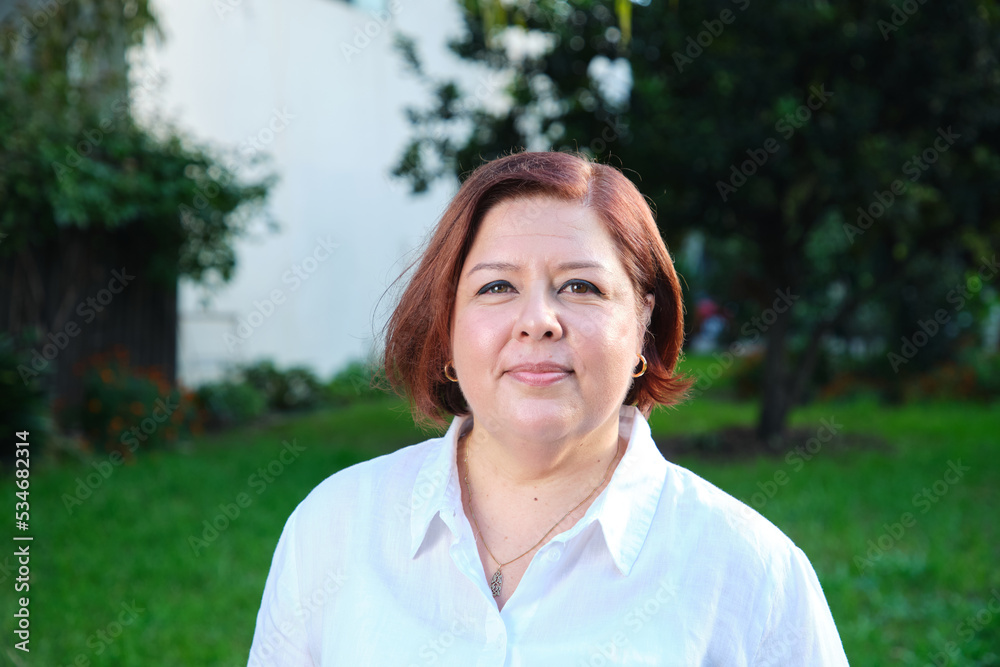Smiling middle aged woman with a short hair wearing white shirt Smiling middle aged woman with a short hair wearing white shirt