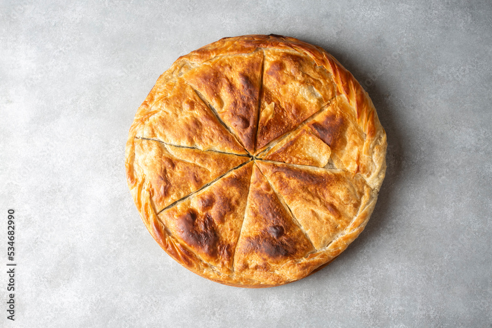 Spanakopita, greek phyllo pastry pie with spinach and feta cheese filling. Delicious handmade pies. Turkish name; el acmasi borek Spanakopita, greek phyllo pastry pie with spinach and feta cheese filling. Delicious handmade pies. Turkish name; el acmasi borek