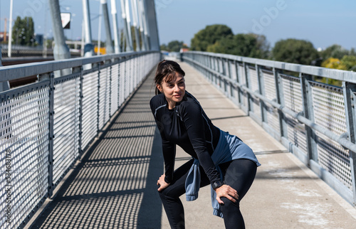 Young woman cancer survivor decides to change her way of life after illness and start practicing every morning as new life routine. Female workout training outdoor for health and happiness. © Srdjan