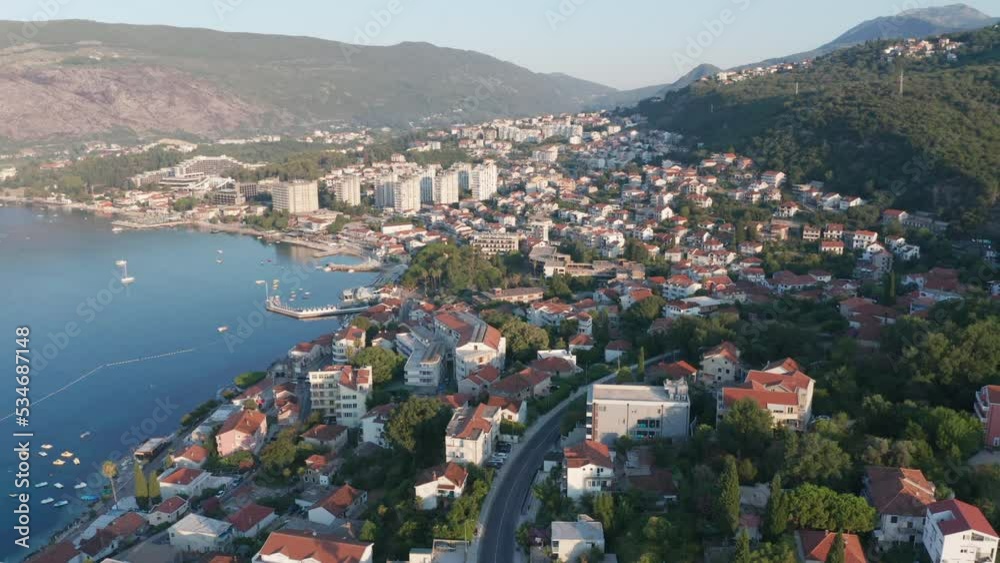 Igalo, Herceg Novi - coastal town in Montenegro. City on the coast of Adriatic sea on the Mediterranean. Aerial drone view of an urban landscape on the shore, featuring houses and apartment buildings. Igalo, Herceg Novi - coastal town in Montenegro. City on the coast of Adriatic sea on the Mediterranean. Aerial drone view of an urban landscape on the shore, featuring houses and apartment buildings.