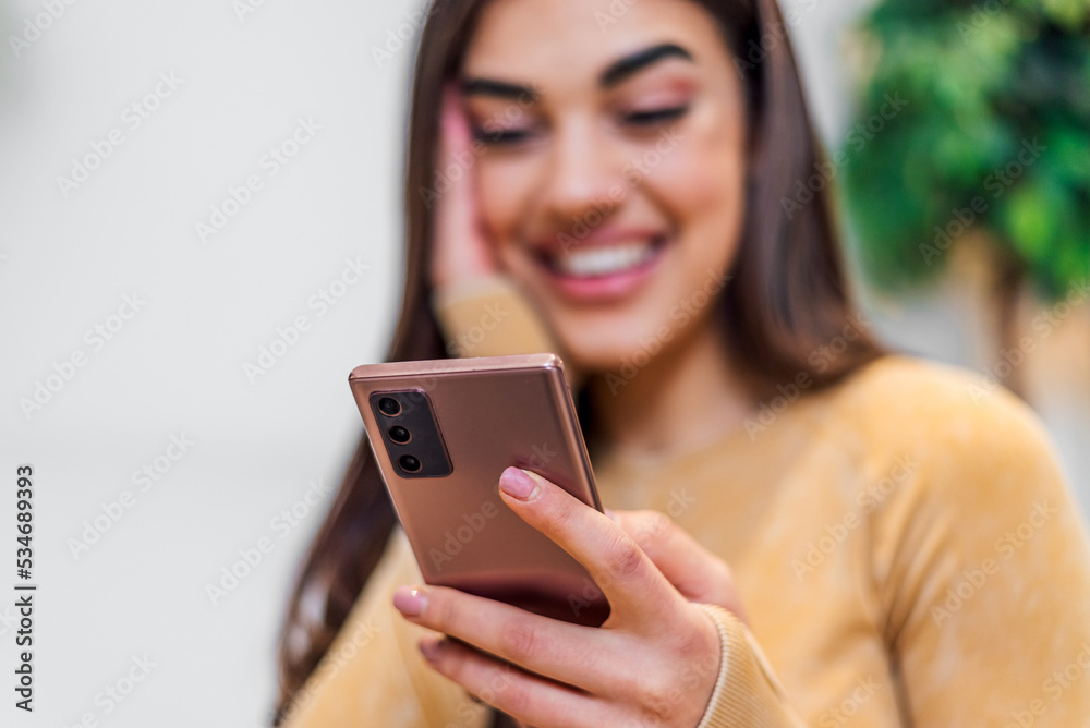 Closeup shot of mobile phone, being used by happy young woman. Closeup shot of mobile phone, being used by happy young woman.