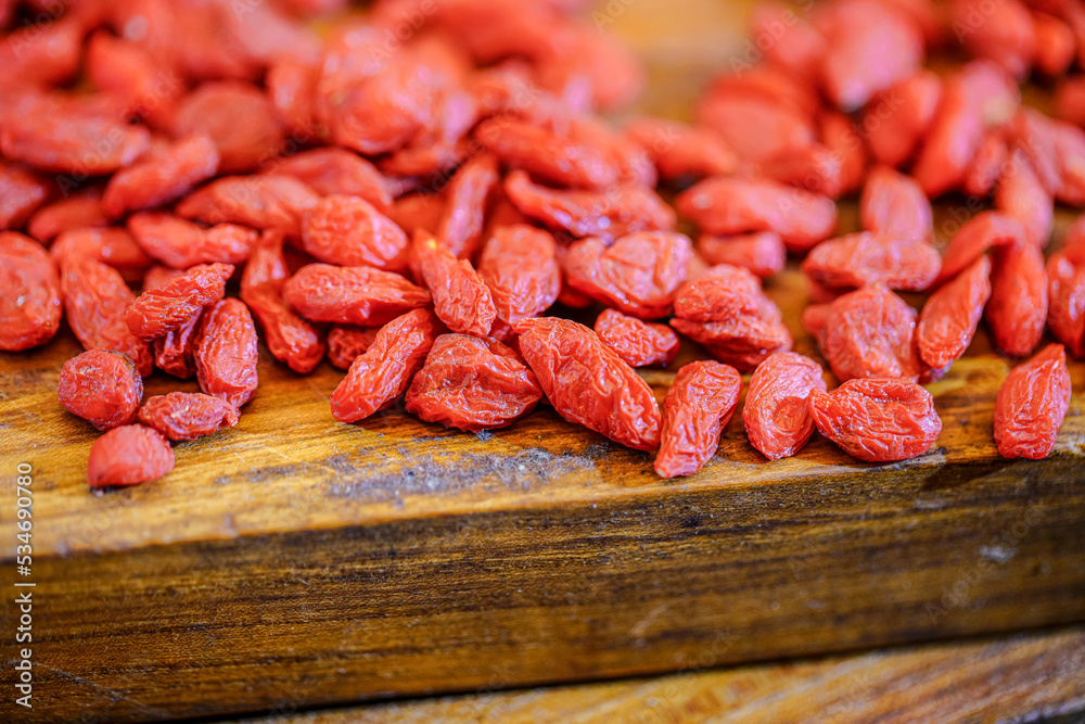 There are many naturally dried red wolfberries on the table There are many naturally dried red wolfberries on the table