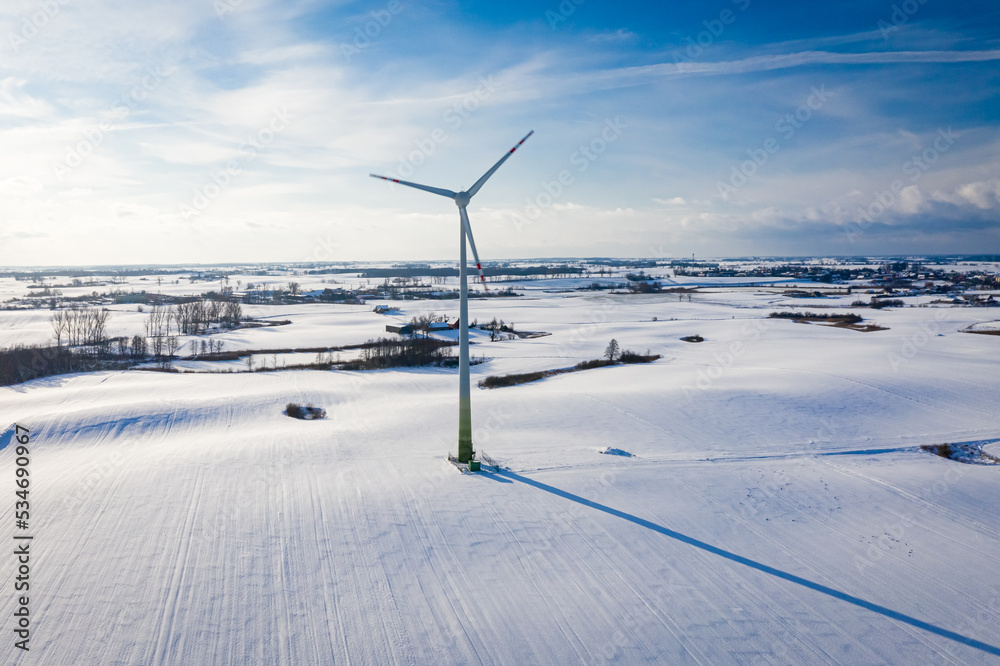 Wind turbine on snowy field. Alternative energy. Green energy. Wind turbine on snowy field. Alternative energy. Green energy.