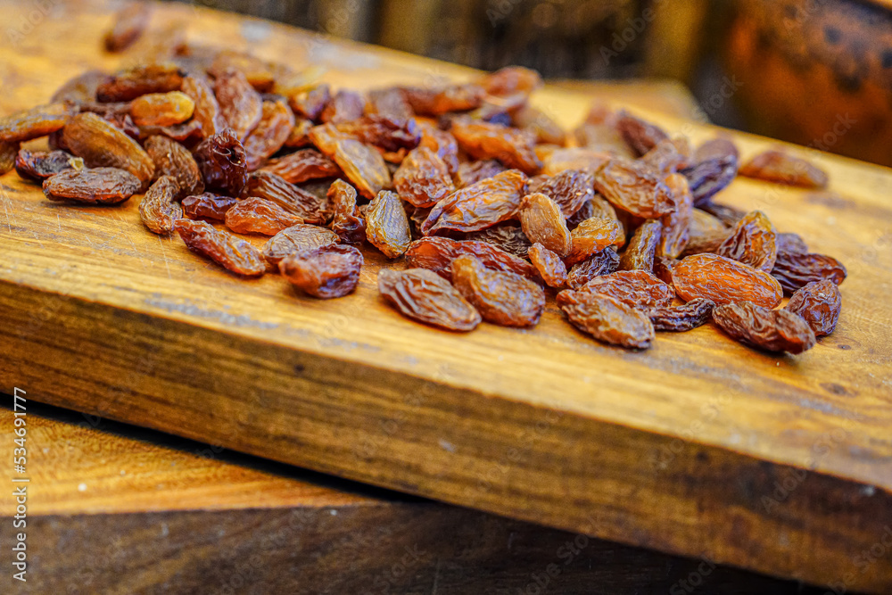 There are many naturally dried red raisins on the table There are many naturally dried red raisins on the table