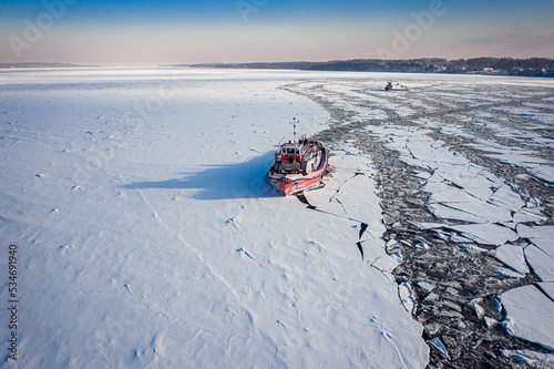 Icebreakers on river in win...