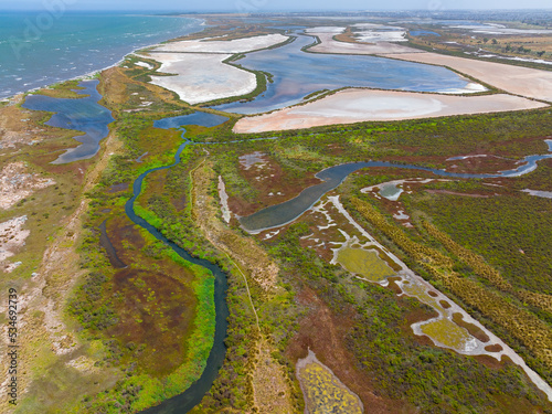 Aerial view of coastal wetlands with colourful vegetation and dry salt lakes photo
