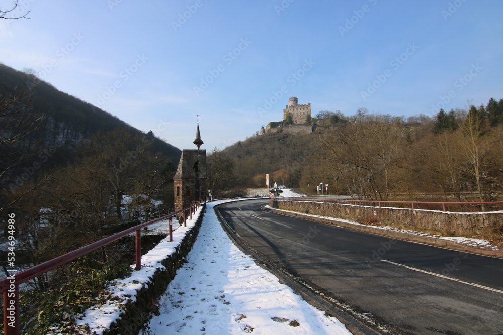 The Pyrmont mill below the Pyrmond castle on the Wahlbach and Eltzbach with a waterfall and historic bridge. Wintry morning in Germany The Pyrmont mill below the Pyrmond castle on the Wahlbach and Eltzbach with a waterfall and historic bridge. Wintry morning in Germany