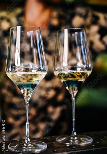 Two glasses of cold dry white wine on bar