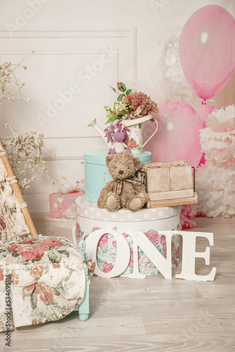 pink and white decoration for a 1st birthday cake smash studio photo shoot with balloons, paper decor, cake and topper. High quality photo