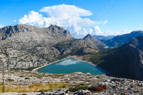 View of Puig Major and Embassament de Cúber in Mallorca, Spain. The reservoir is in the Serra de Tramuntana mountain range in front of the island's highest peak, with dramatic clouds in the background photo