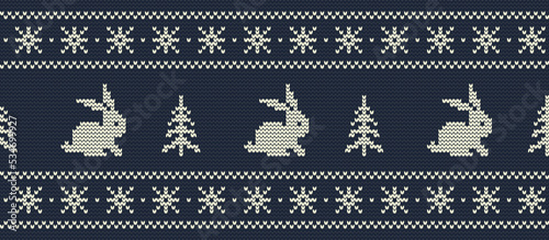 Knitted pattern with rabbits and christmas trees on a dark blue background. Christmas and New Year background. Seamless border. 2023 Year of the Rabbit. Ornament. Vector illustration