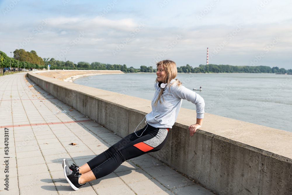 Young woman cancer survivor decides to change her way of life after illness and start practicing every morning as new life routine. Female workout training outdoor for health and happiness.