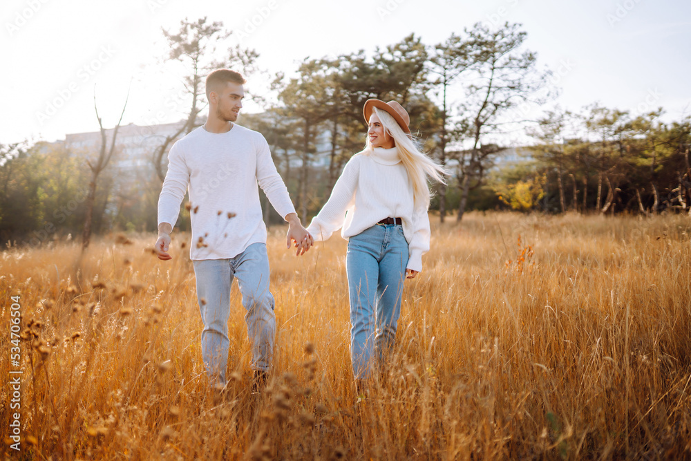 Loving  Couple  travel together, hike and walk in the autumn park in nature. People, lifestyle, relaxation and vacations concept.