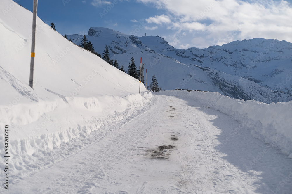beautiful white landscape, high mountains Swiss Alps, wide alpine winter road cleared, large snowdrifts on the side, Healthy Lifestyle Concept, Winter Activity, travel by car