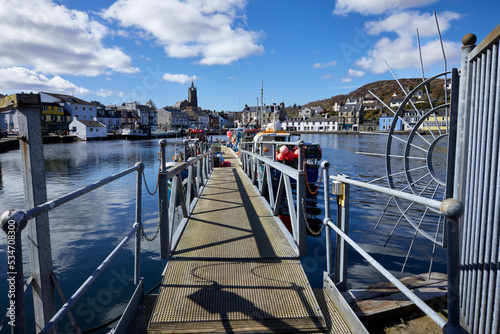 The harbour at East Loch Tarbert with a gang way leading to moored fishing craft. East Loch Tarbert, Argyll and Bute. Scotland photo