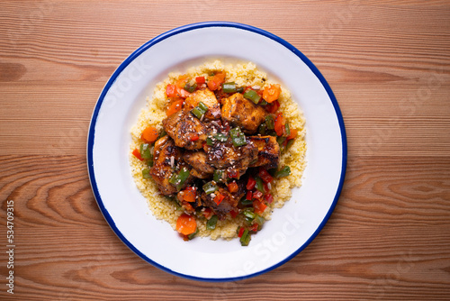 Marinated chicken with vegetables and couscous. Traditional African recipe.