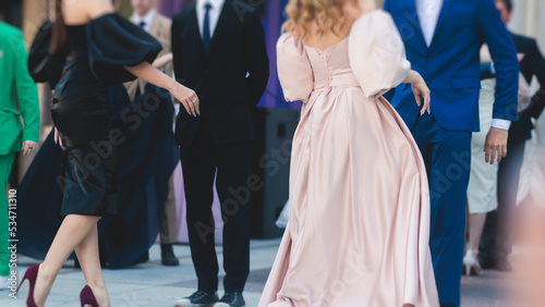 High school graduates dancing waltz and classical ball dance in dresses and suits on school prom graduation, classical ballroom dancers dancing, waltz, quadrille and polonaise