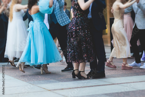 High school graduates dancing waltz and classical ball dance in dresses and suits on school prom graduation, classical ballroom dancers dancing, waltz, quadrille and polonaise photo
