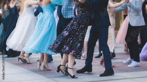 High school graduates dancing waltz and classical ball dance in dresses and suits on school prom graduation, classical ballroom dancers dancing, waltz, quadrille and polonaise photo