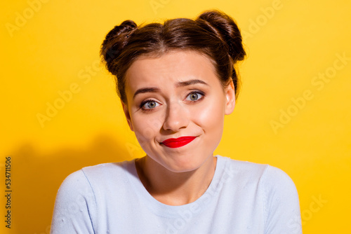 Photo of funny young female don't know what to do feel hesitant doubtful isolated on yellow color background