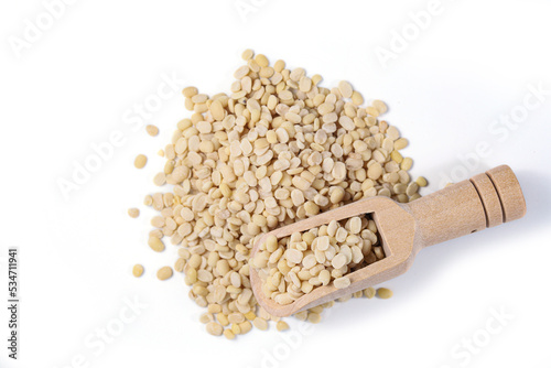 White Lentils (Urad Dal). White Lentils with wooden spoon on white background photo