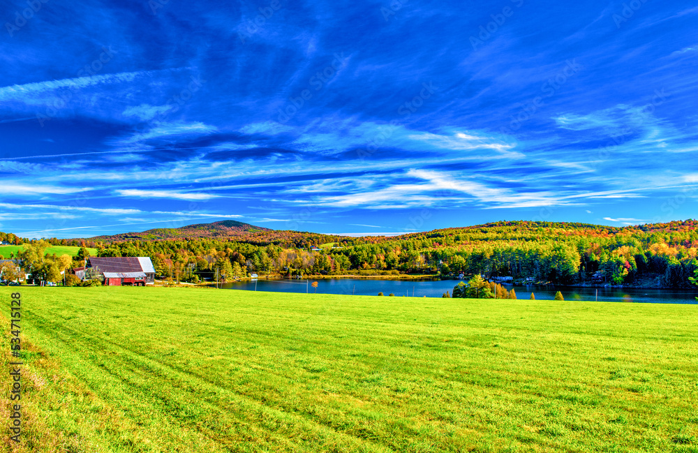 Lake and meadows of New England in foliage season