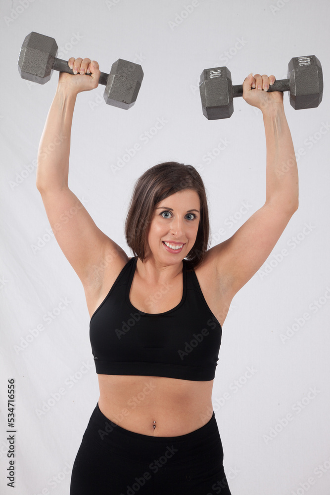 Happy woman lifting dumbbells Happy woman lifting dumbbells