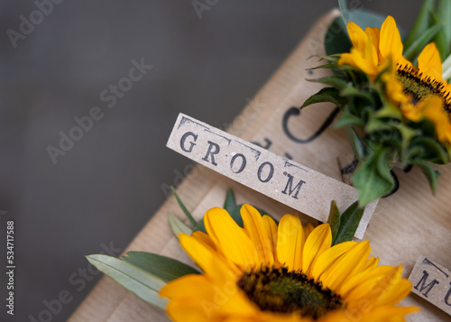 Canvastavla Wedding groom name badge with printed text font on sunflower corsage favour