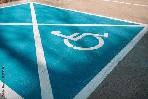 Handicapped parking spot, blue square on black asphalt