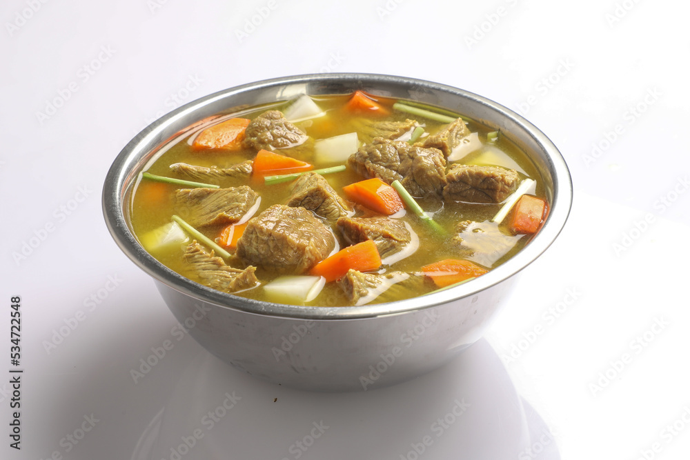 Beef with carrots, onions various fresh vegetables in a pot - colorful fresh clear spring soup. Rural kitchen scenery vegetarian stock Beef with carrots, onions various fresh vegetables in a pot - colorful fresh clear spring soup. Rural kitchen scenery vegetarian stock