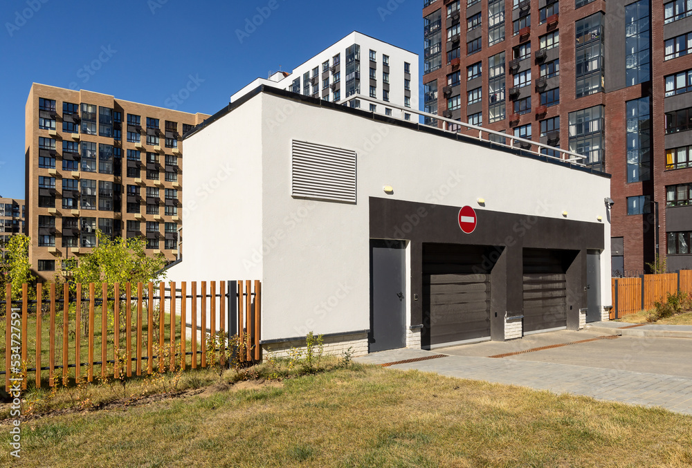 Fototapeta premium Underground parking entrance with automatic gate in the residential complex 