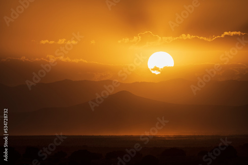 Usa, New Mexico, Santa Fe, Sun setting over desert in wildfire smoke