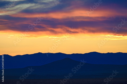 Usa, New Mexico, Santa Fe, Dramatic sunset sky over desert landscape