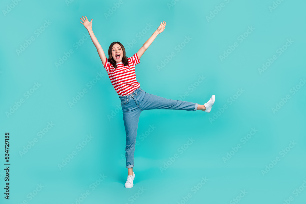 Full length photo of adorable funny girl dressed red t-shirt smiling having fun dancing isolated teal color background Full length photo of adorable funny girl dressed red t-shirt smiling having fun dancing isolated teal color background