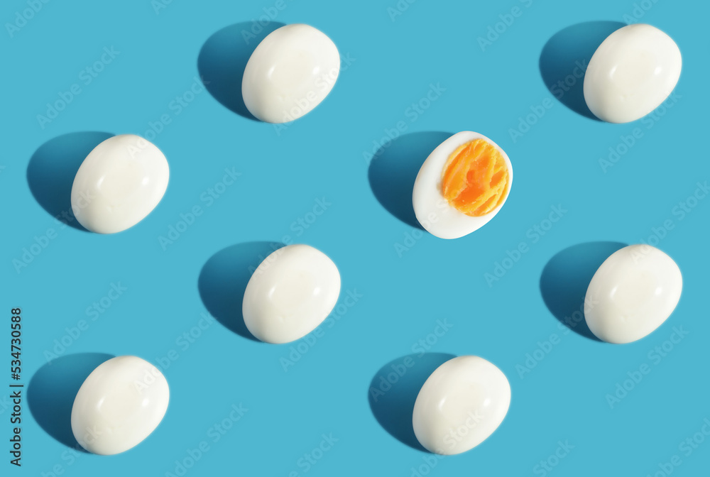 Difference boiled eggs on blue background. Think different concept and business success idea