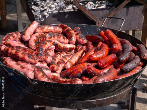 Fresh red and white sausages made on the open fire