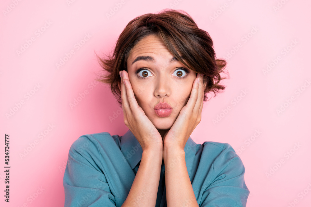 Photo of lovely impressed person hands touch cheeks pouted lips isolated on pink color background Photo of lovely impressed person hands touch cheeks pouted lips isolated on pink color background