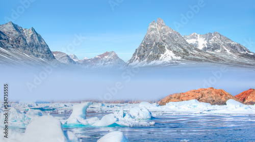 Arctic landscape of Greenland in Summer. Beautiful view of mountains with Snowy peaks and iceberg © muratart
