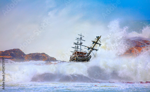 An old sailing ship that crashed into a cliff and strong sea wave - Shipwrecked off the coast - An shipwreck or abandoned shipwreck