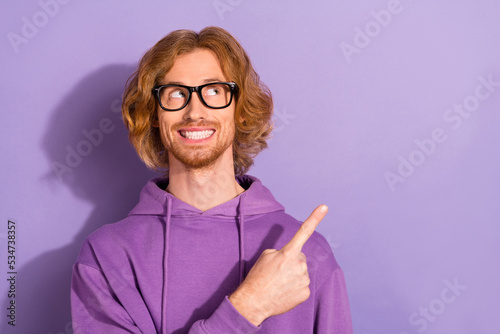 Fototapeta Naklejka Na Ścianę i Meble -  Photo of nerd curly orange hairstyle guy indicate promotion wear eyewear purple sportcloth isolated on violet color background