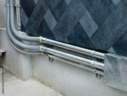 Rows of Electrical Cable Piping Along the Wall