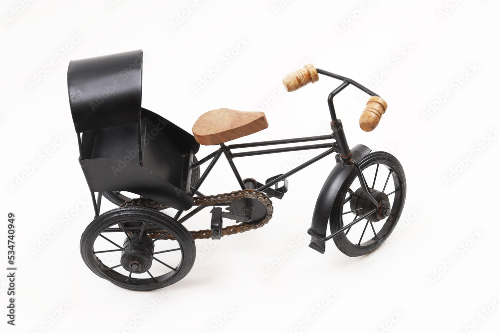 Fototapeta premium Decorative souvenir bike. Antique tricycle-carriage. Shallow depth of field