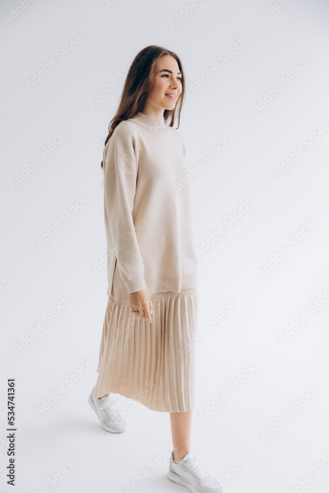 29.04.22 Kyiv, Ukraine: stylish portrait of a young woman posing for a photo on a white background studio cyclora with natural daylight from the window 29.04.22 Kyiv, Ukraine: stylish portrait of a young woman posing for a photo on a white background studio cyclora with natural daylight from the window